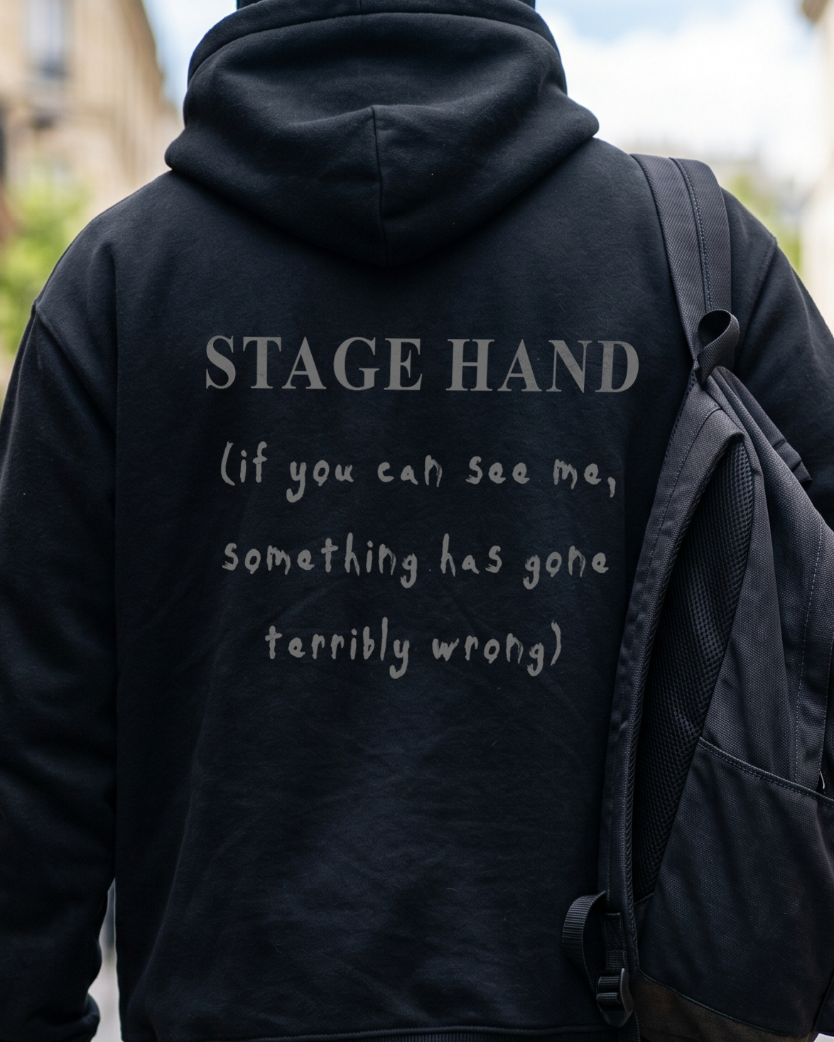 black hoodie reading stage hand if you can see me something has gone terribly wrong